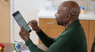 man using tablet in home